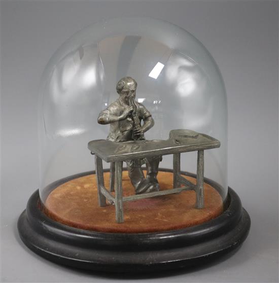 A lead figure of a joiner under a small Victorian dome Height of dome and stand 17cm